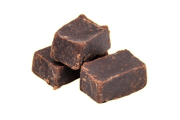 Three chocolate fudge pieces stacked on each other against a light background.