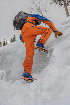 Man uses microspikes to climb on ice