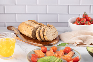 Fresh composition with healthy toasts, kombucha and cherry tomatoes. Bright table and natural elements. Clean style. Concept of healthy lifestyle