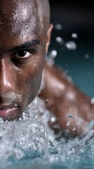 Focused swimmer emerging from water