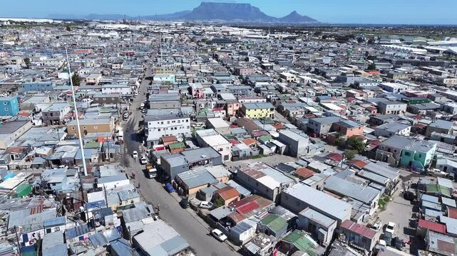 Aerial view of informal housing and shacks in the Du Noon settlement outside Cape Town showing population density and poverty. Table Mountain in back. 
