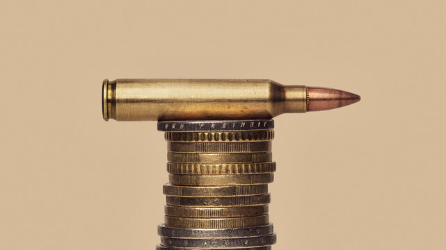 Euro Defense Spending - still life of bullet cartridge on stack of Euro coins
