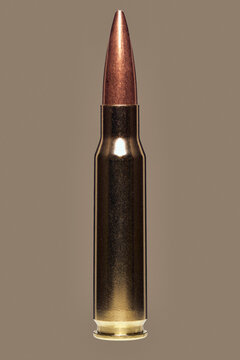 Close up studio shot .308 Winchester 7.62 bullet on brown background
