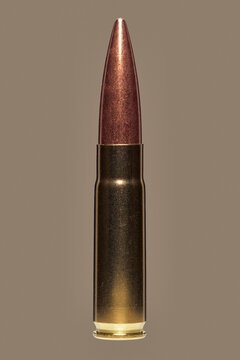 Close up studio shot .300 bullet cartridge on brown background
