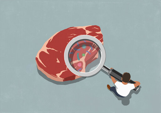 Man holding large magnifying glass over raw steak meat, exposing bacteria
