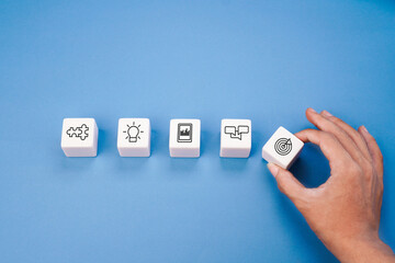White blocks with business ideology concept icon hold by hand