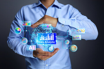 Data analytic concept with businessmen hold information in his hands to analyze and find marketing and business directions from information obtained all over the world