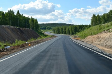 Fototapeta premium Blue Sky Road. Asphalt Highway Through Green Forest Landscape Under Summer Sky