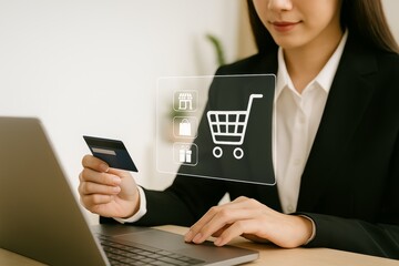 Woman holding credit card and using laptop for online shopping with digital cart icon overlay.
