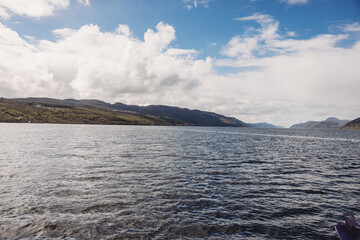 Wide freshwater loch with distant hills, calm natural landscape