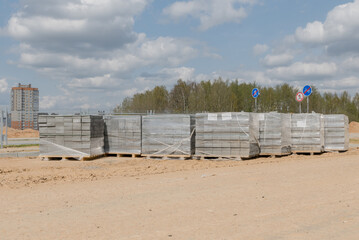 Interlock, Small cement bricks or Tiles for pavement area. Interlock pallet on construction site used for walking pathway or crossing pavement area. Block or Tabook, Concrete block on White Sand.