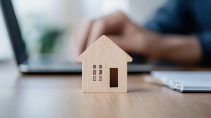 House on table, working at laptop