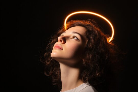 Young woman looking up with halo