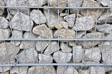 Stacked Granite Rocks in Wire Cage for Industrial or Landscape Design