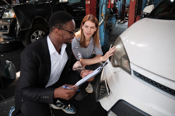 Warranty service business, Black male insurance agent inspector records crash car damage bumper,...