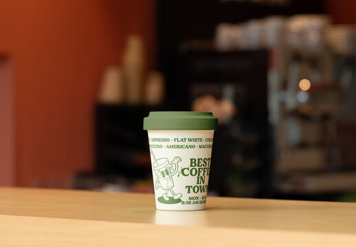 Mockup of a Take Away Coffee Cup with lid on a Counter