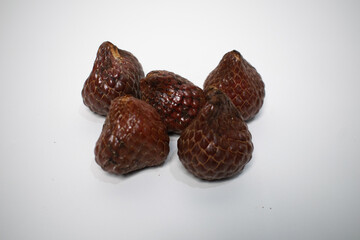 kelubi fruit which shows its unique skin texture, resembling scales, and natural shape.