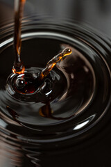 Macro soy sauce splash, flow and sprinkle.