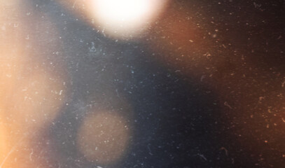grainy colorful warm orange light leaks on black background with dust texture. abstract damaged scratched retro film analog effect for using over photos as overlay or screen filter