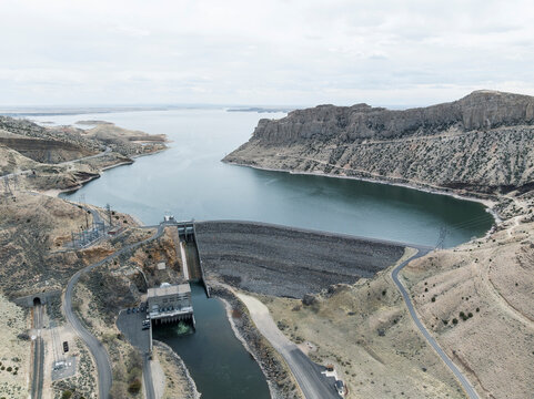 Aerial landscape of damn with hydro power and reservoir in the background. Shoshoni, Wyoming
