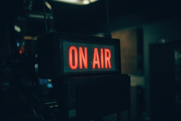 Illuminated 'On Air' Sign in Dark Studio Setting with Moody Lighting for Broadcasting Enthusiasts