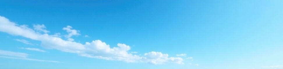 Serene blue sky with wispy white clouds against a bright blue horizon, blue sky, sky view, outdoor scene