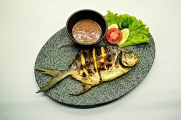 Grilled spadefish (bawal bintang) served with spicy seafood sambal. A savory Indonesian dish rich in flavor, perfect for traditional seafood lovers.