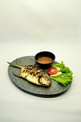 Grilled spadefish (bawal bintang) served with spicy seafood sambal. A savory Indonesian dish rich in flavor, perfect for traditional seafood lovers.