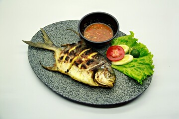 Grilled spadefish (bawal bintang) served with spicy seafood sambal. A savory Indonesian dish rich in flavor, perfect for traditional seafood lovers.