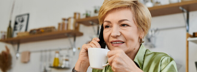 Senior woman enjoys a warm cup of tea while engaging in a friendly conversation at home