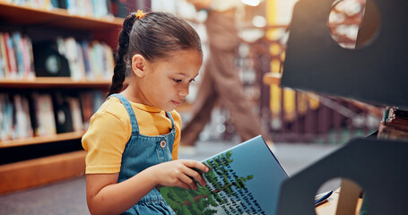 Girl, child and reading book in library, relax and smile with fantasy, education and novel. School, student and academic growth for development, storytelling and knowledge with vocabulary or learning