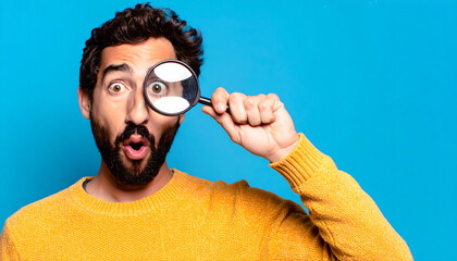 Surprised Man with Magnifying Glass, Close-up Studio Shot on Blue Background