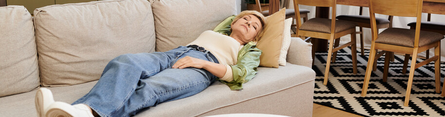 Relaxing afternoon on a cozy couch in a modern living room with a serene senior woman