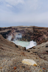 Mount Aso Nakadake volcano crater, Aso-San, caldera, Aso-Kuju National Park hiking, Kyushu island region, Kumamoto prefecture, Japan, eruption with steam and smoke, volcanic desert landscape view