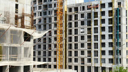 Fototapeta premium construction site under development with cranes and safety nets