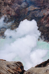Mount Aso Nakadake volcano crater, Aso-San, caldera, Aso-Kuju National Park hiking, Kyushu island region, Kumamoto prefecture, Japan, eruption with steam and smoke, volcanic desert landscape view
