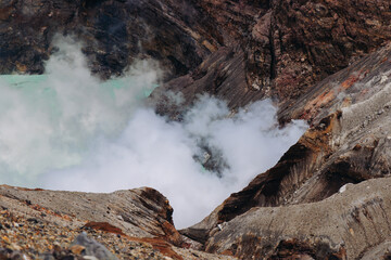Mount Aso Nakadake volcano crater, Aso-San, caldera, Aso-Kuju National Park hiking, Kyushu island region, Kumamoto prefecture, Japan, eruption with steam and smoke, volcanic desert landscape view