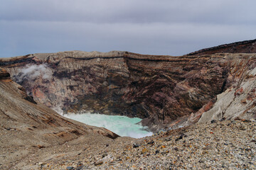 Mount Aso Nakadake volcano crater, Aso-San, caldera, Aso-Kuju National Park hiking, Kyushu island region, Kumamoto prefecture, Japan, eruption with steam and smoke, volcanic desert landscape view