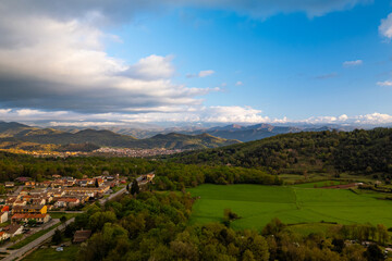 Obraz premium spectacular aerial view of Garrotxa region in Catalonia, Spain, at sunset with cloudy sky. Scenic view of natural landscape nearby Olot