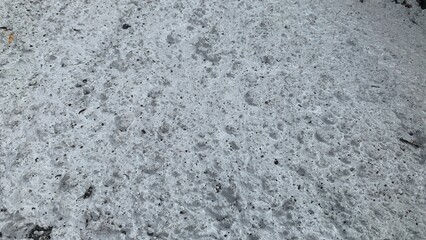 gravel surface that has been cemented and painted white