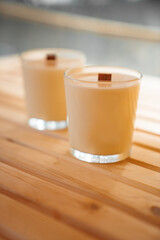 Scented candles on a wooden table. 