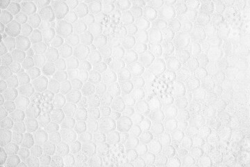 Textured white surface resembling bubble wrap in a bright, well-lit setting