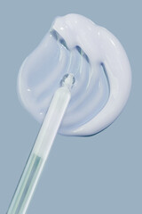 Pipette serum texture white swatch sample on light navy blue background. Cosmetic beauty skin care...