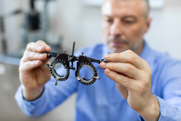 Middle aged man patient under eye vision examination in eyesight ophthalmological correction...