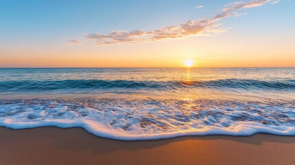Obraz premium Sunset over gentle ocean waves on a sandy beach.