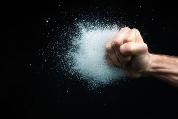 Person expresses anger by shattering a glass, creating a moment of chaos in an intense setting