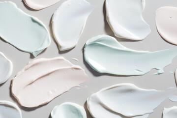 Face or body white blue pink cream gel peeling scrub mask assortment set hair balm grey background. Cosmetic beauty skin care product