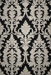 An elegant black and white damask wallpaper featuring intricate, swirling patterns and floral motifs, adding a touch of vintage sophistication to any space.
