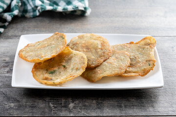Tortillitas de camarones on wooden table. Traditional spanish food
