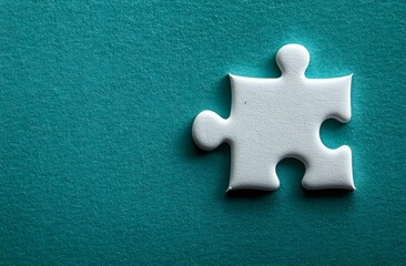 Obraz premium Single white jigsaw puzzle piece casting soft shadow on turquoise textured background, symbolizing solution, connection and business strategy concepts.